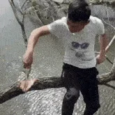 man-sitting-on-branch-chopping.gif